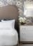 49 - Sissy Yellen, Elegant bedroom design featuring a floral wallpaper accent, an upholstered arched headboard, luxury embroidered bedding, a modern white nightstand, and a fresh white flower arrangement, creating a sophisticated and calming interior decor.