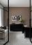 55 - Sissy Yellen, Modern home office design featuring a black lacquered sideboard adorned with abstract wall art, a minimalist desk setup, a textured neutral wallpaper backdrop, and contemporary furniture complemented by sheer white curtains and sleek black and white decor elements.